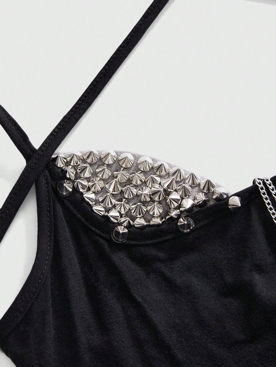 Women's black halter backless crop top with criss cross knot design and spaghetti straps.