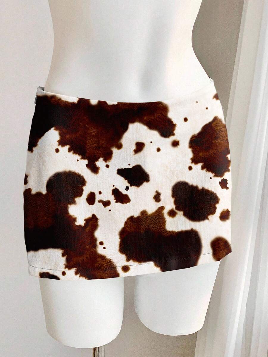 Women's white 100% cotton low waist mini skirt featuring a tropical print and zipper detail.