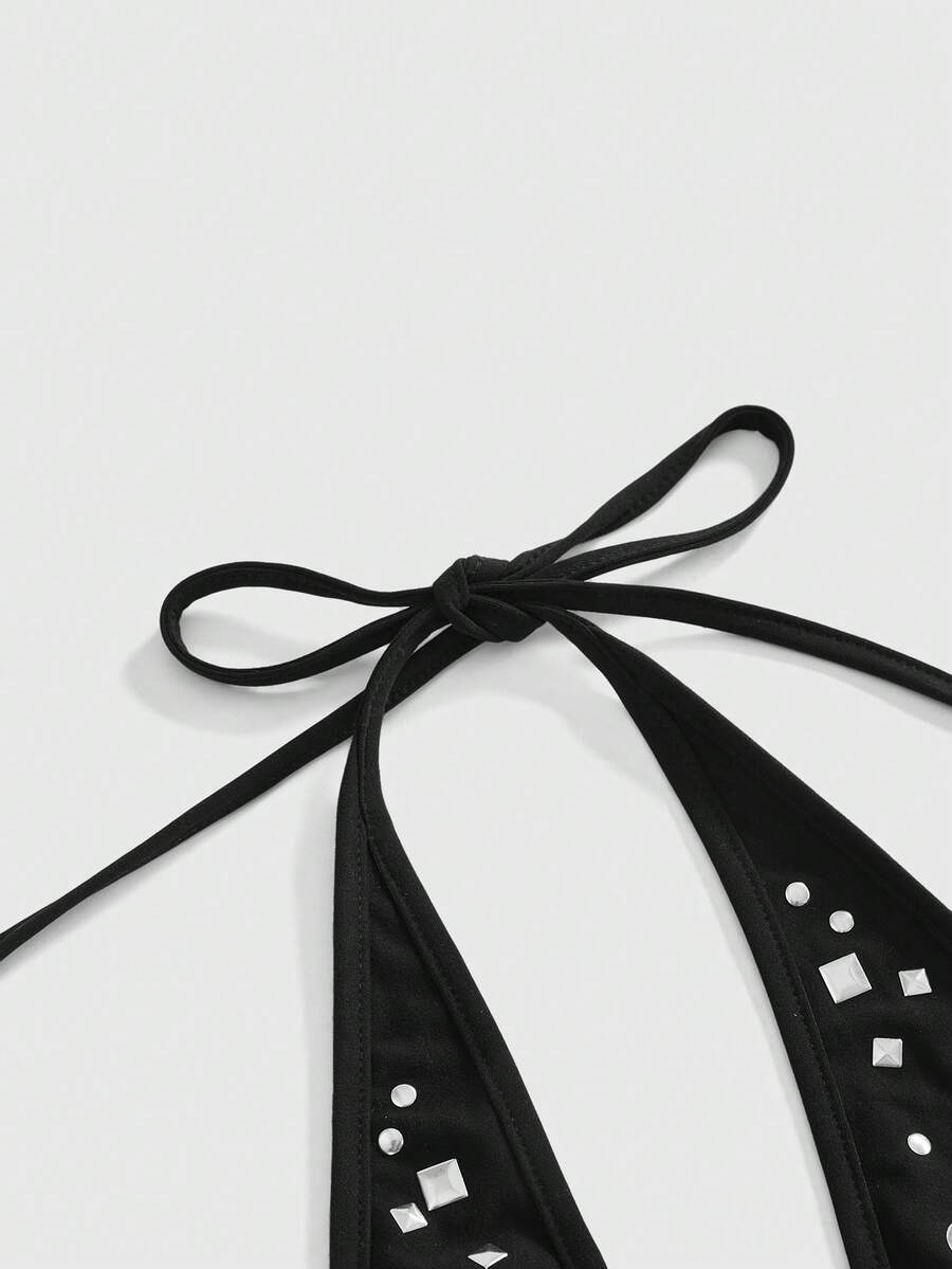 Women's black halter tank top featuring a lace-up tie-back design and slim fit cut.