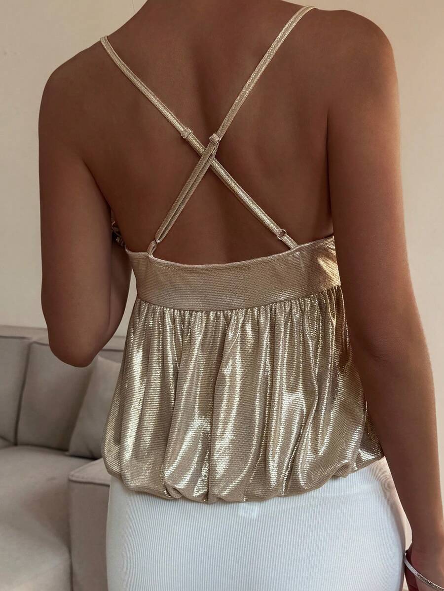 Burgundy sequin spaghetti strap cami top featuring a backless design and flared ruffle hem.