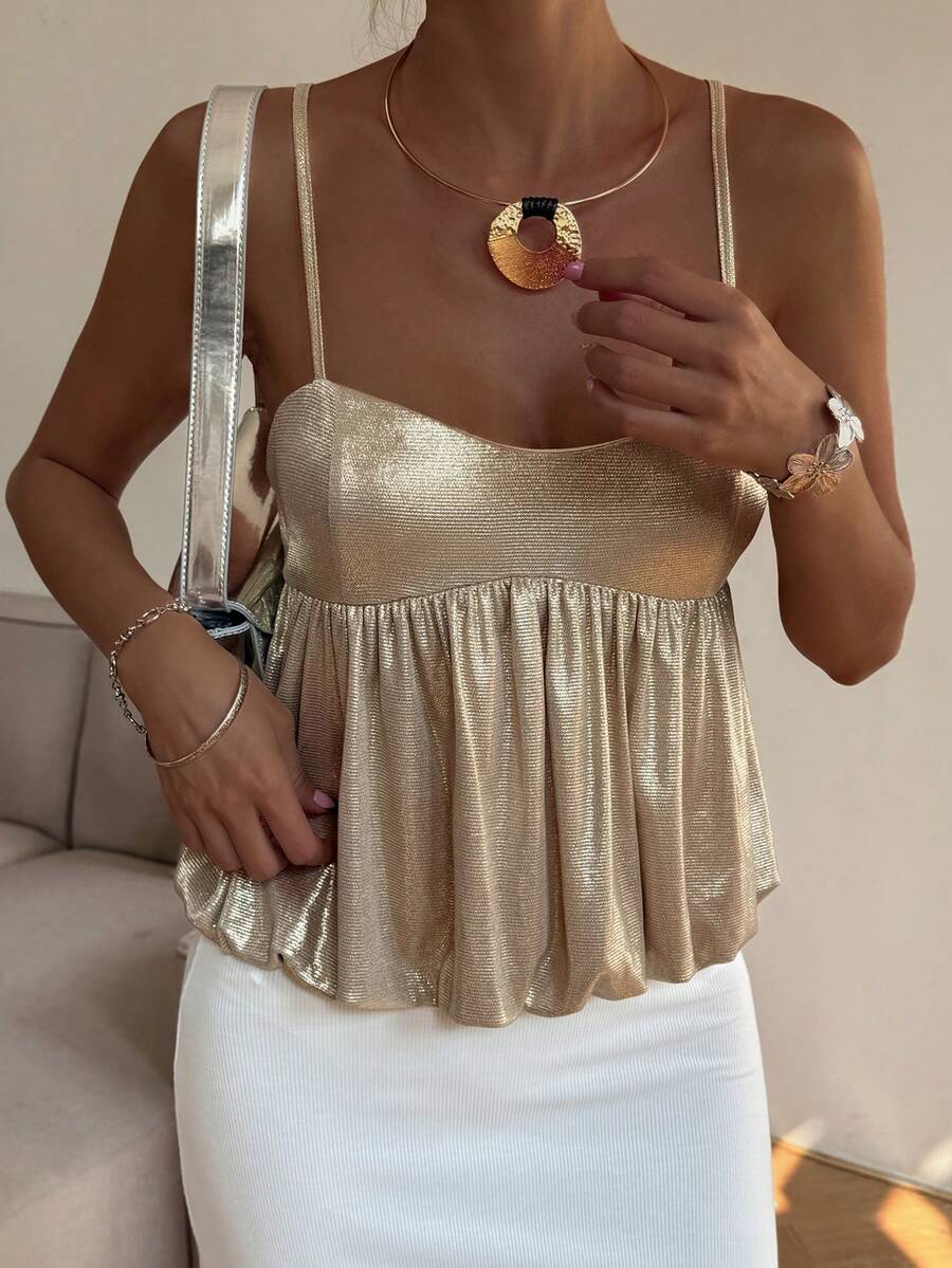 Burgundy sequin spaghetti strap cami top featuring a backless design and flared ruffle hem.