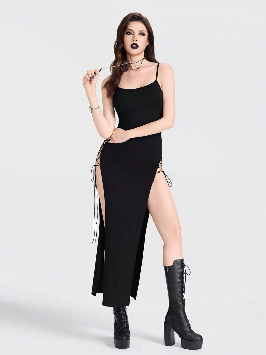 Women's black knitted cami midi dress with spaghetti straps, slim fit silhouette, and an asymmetrical zipper split thigh detail.