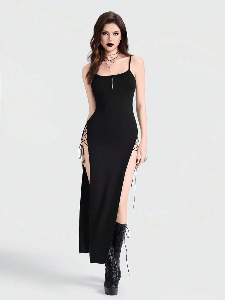 Women's black knitted cami midi dress with spaghetti straps, slim fit silhouette, and an asymmetrical zipper split thigh detail.