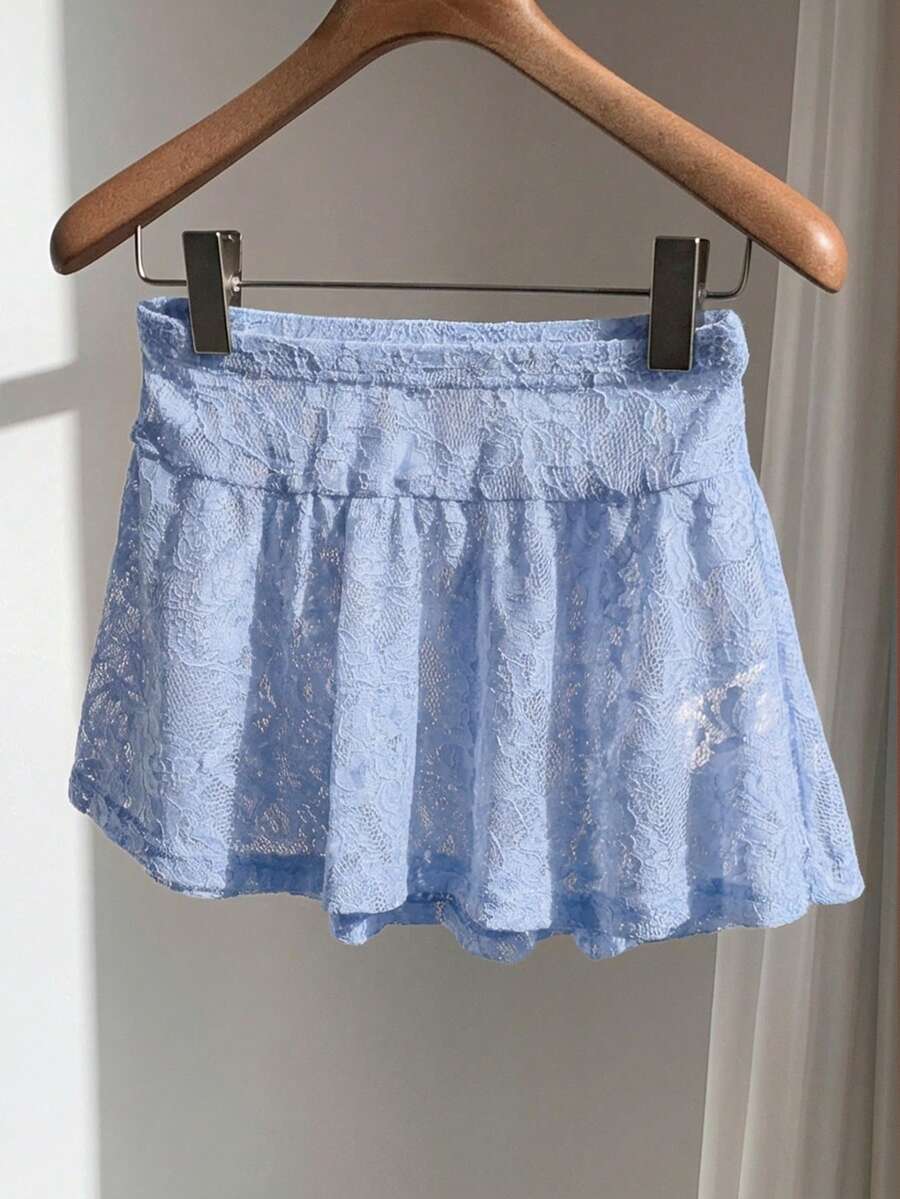 Women's black semi-sheer knitted lace mini skirt featuring a flared ruffle hem and low waist design
