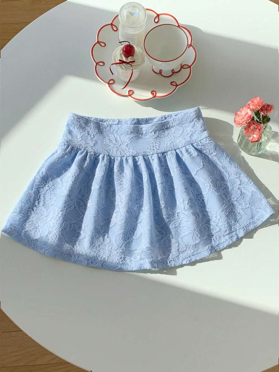 Women's black semi-sheer knitted lace mini skirt featuring a flared ruffle hem and low waist design