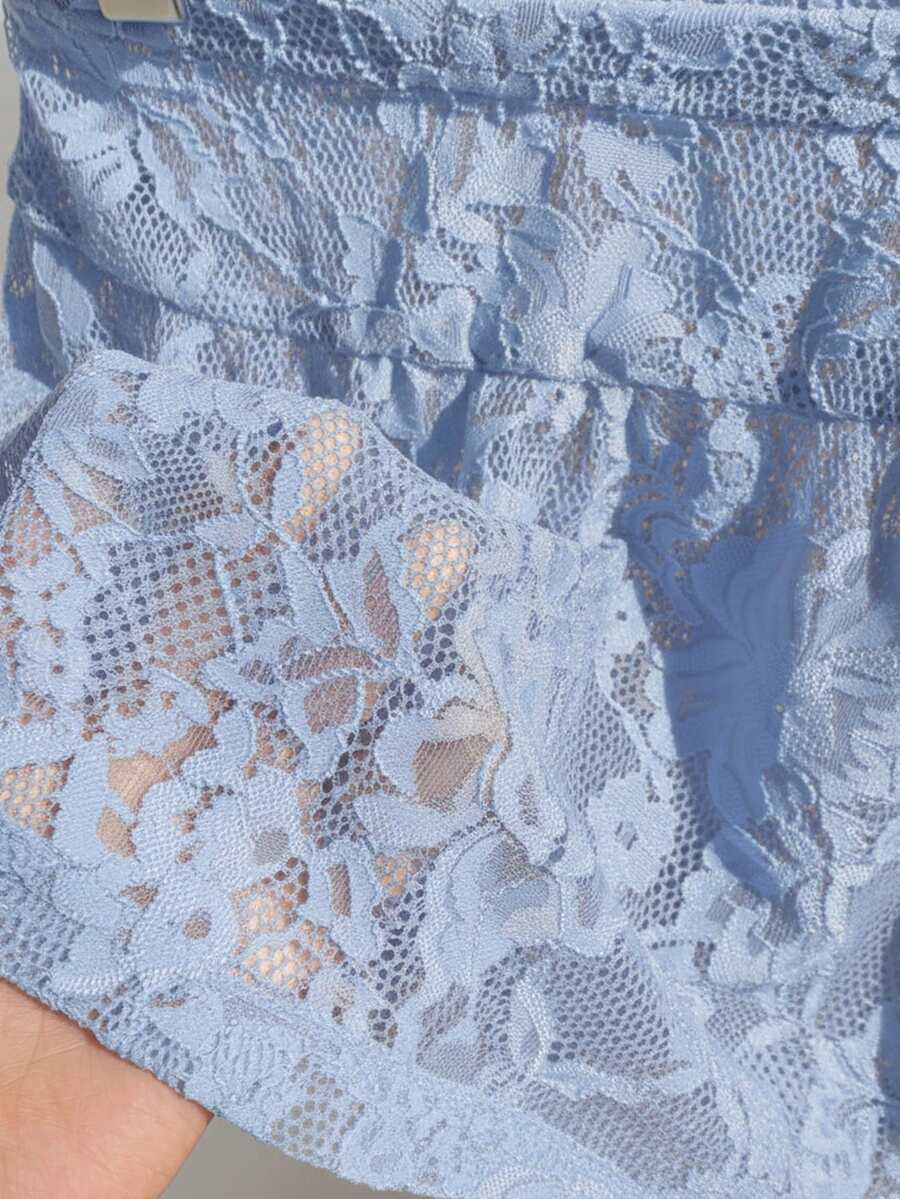 Women's black semi-sheer knitted lace mini skirt featuring a flared ruffle hem and low waist design
