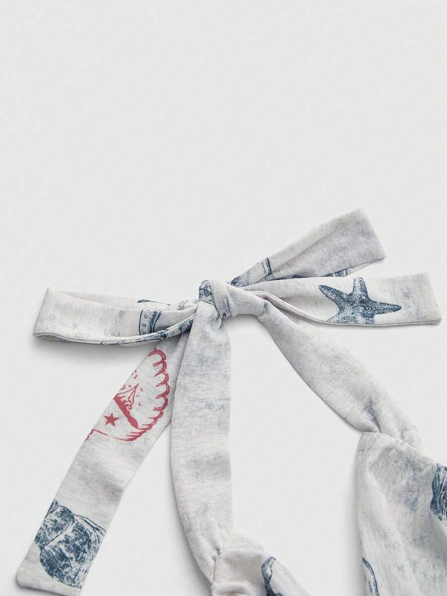 Blue halter cami tank top for women featuring an ocean fish and starfish print, spaghetti straps, slim fit knitted fabric, and a backless lace-up tie design.