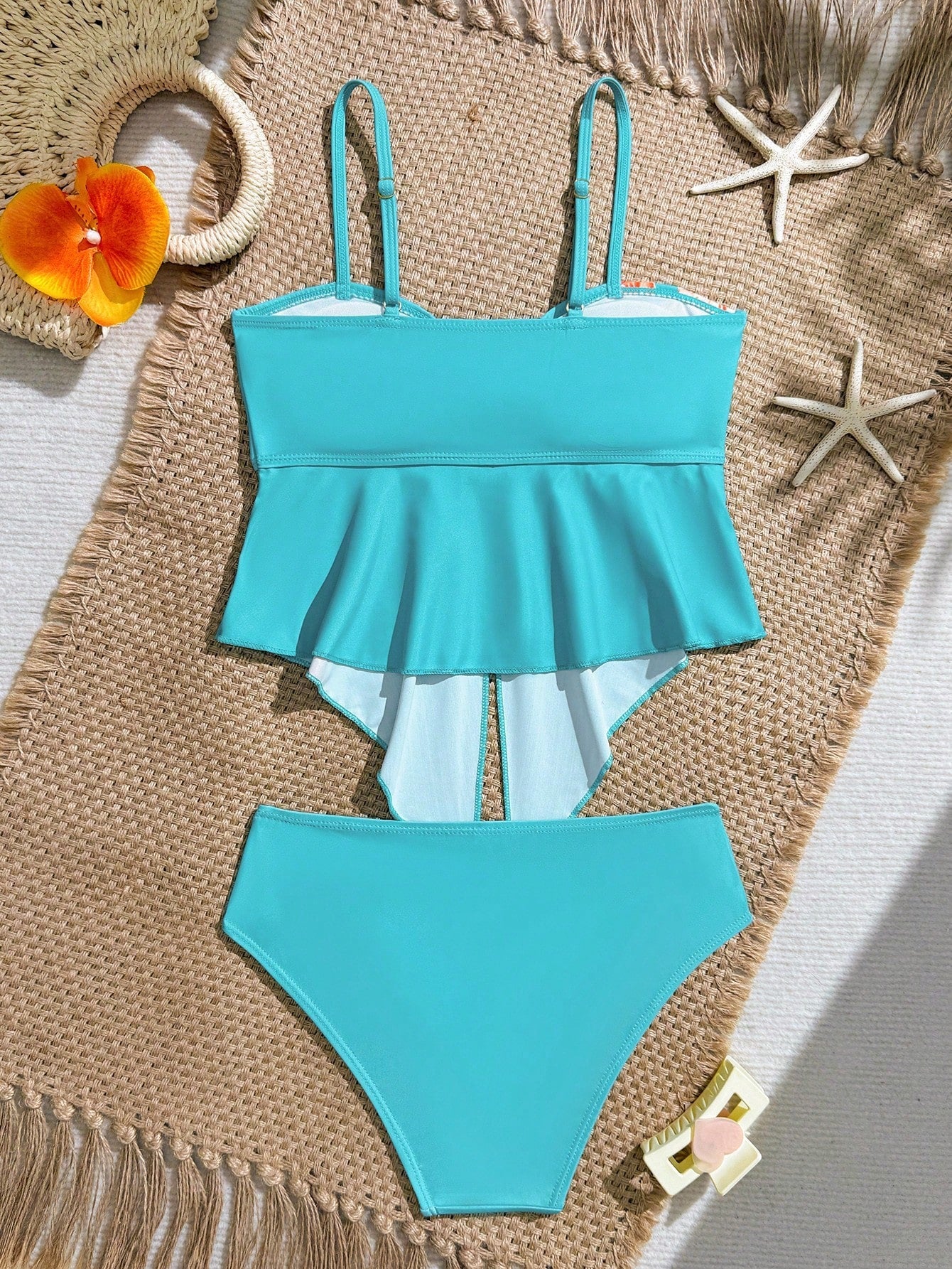 Tween girls two-piece tankini swimwear set with spaghetti straps, asymmetrical design, and 3D rose detail. Features a plant-pattern top and mid-waist bottoms in stretchy fabric for beach or pool wear.