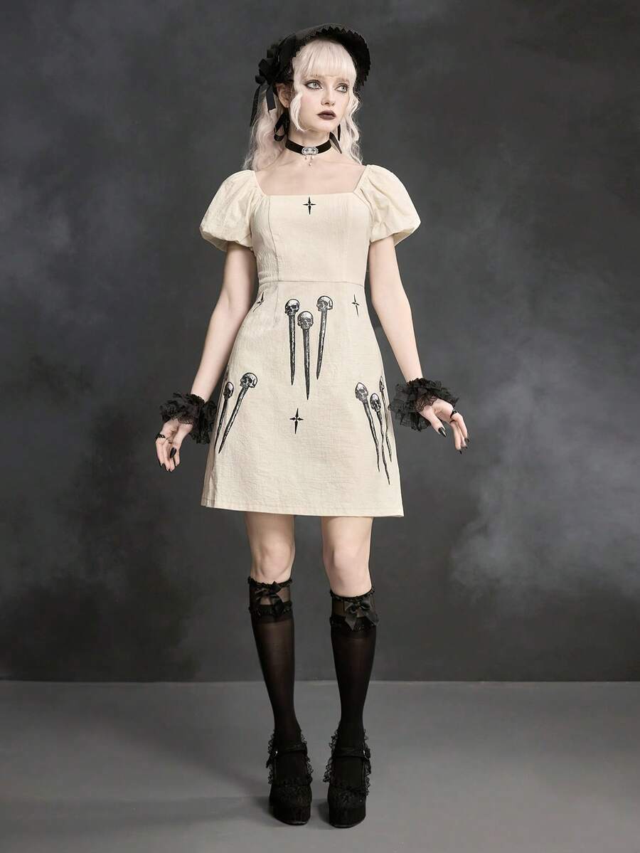 White Goth mini skater dress for women featuring dark skull graphic print, square neckline, short puff sleeves, and lace-up detail.