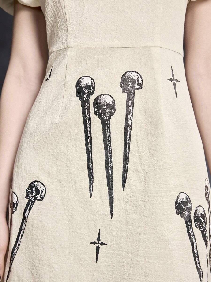 White Goth mini skater dress for women featuring dark skull graphic print, square neckline, short puff sleeves, and lace-up detail.
