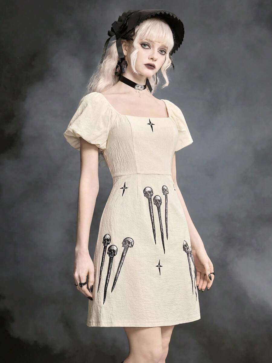 White Goth mini skater dress for women featuring dark skull graphic print, square neckline, short puff sleeves, and lace-up detail.