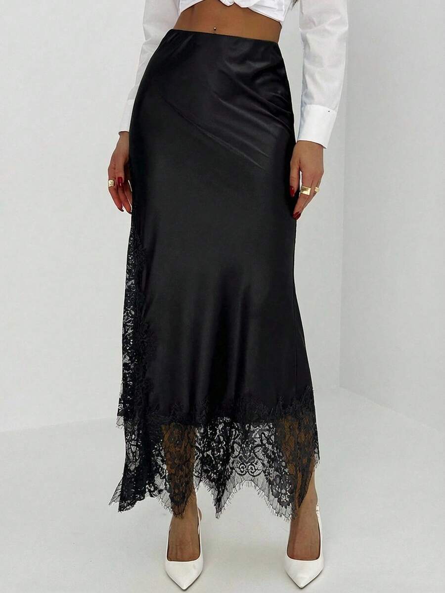 Women's elegant black lace patchwork mermaid maxi skirt featuring asymmetrical contrast lace design and low waist fit.
