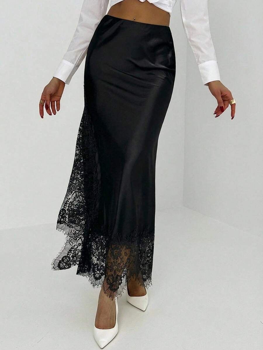 Women's elegant black lace patchwork mermaid maxi skirt featuring asymmetrical contrast lace design and low waist fit.