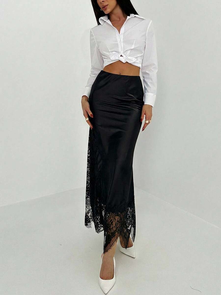 Women's elegant black lace patchwork mermaid maxi skirt featuring asymmetrical contrast lace design and low waist fit.