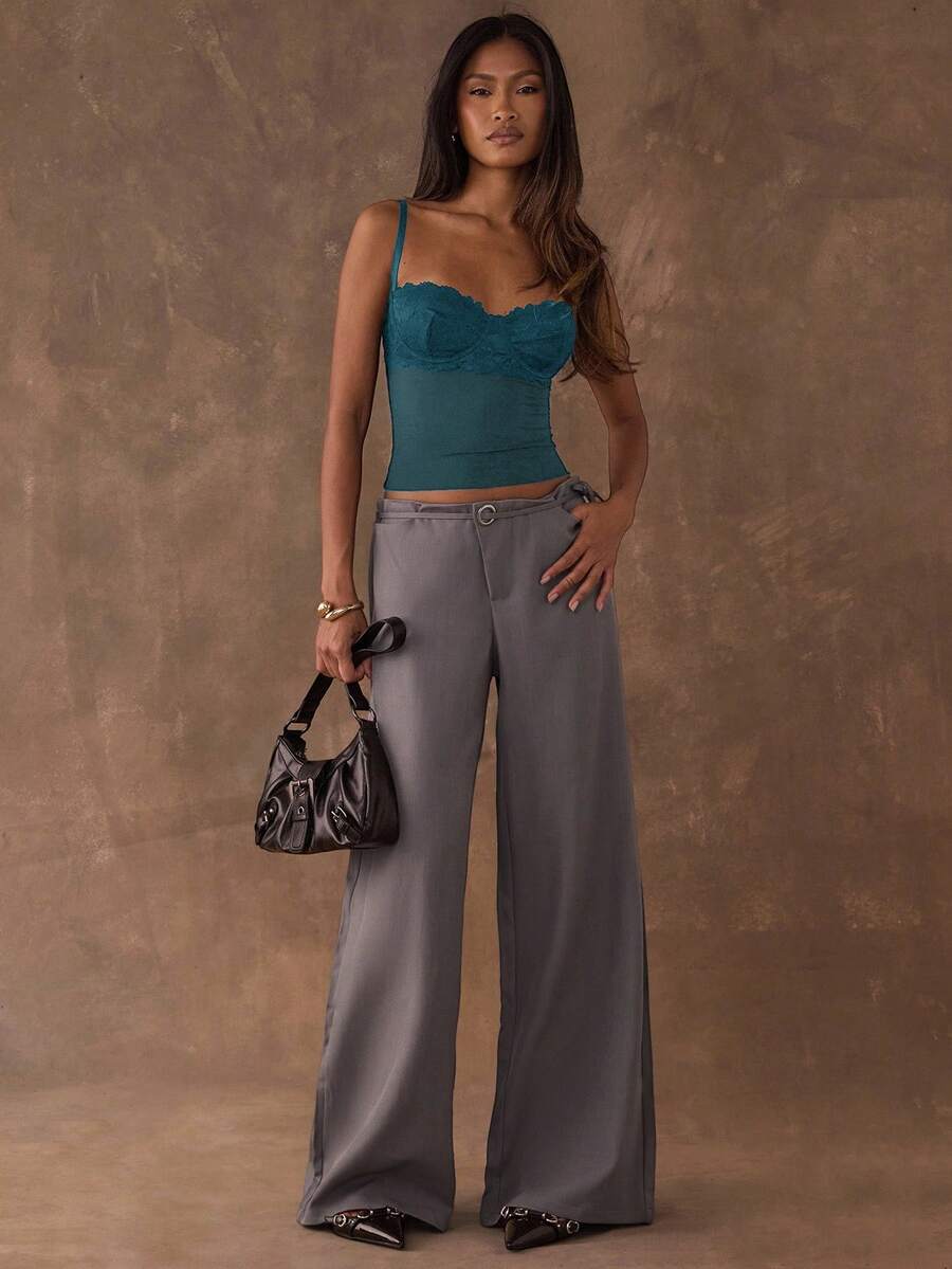 A black slim fit cropped camisole top featuring lace patchwork cup detail, spaghetti straps, and matching arm sleeves.