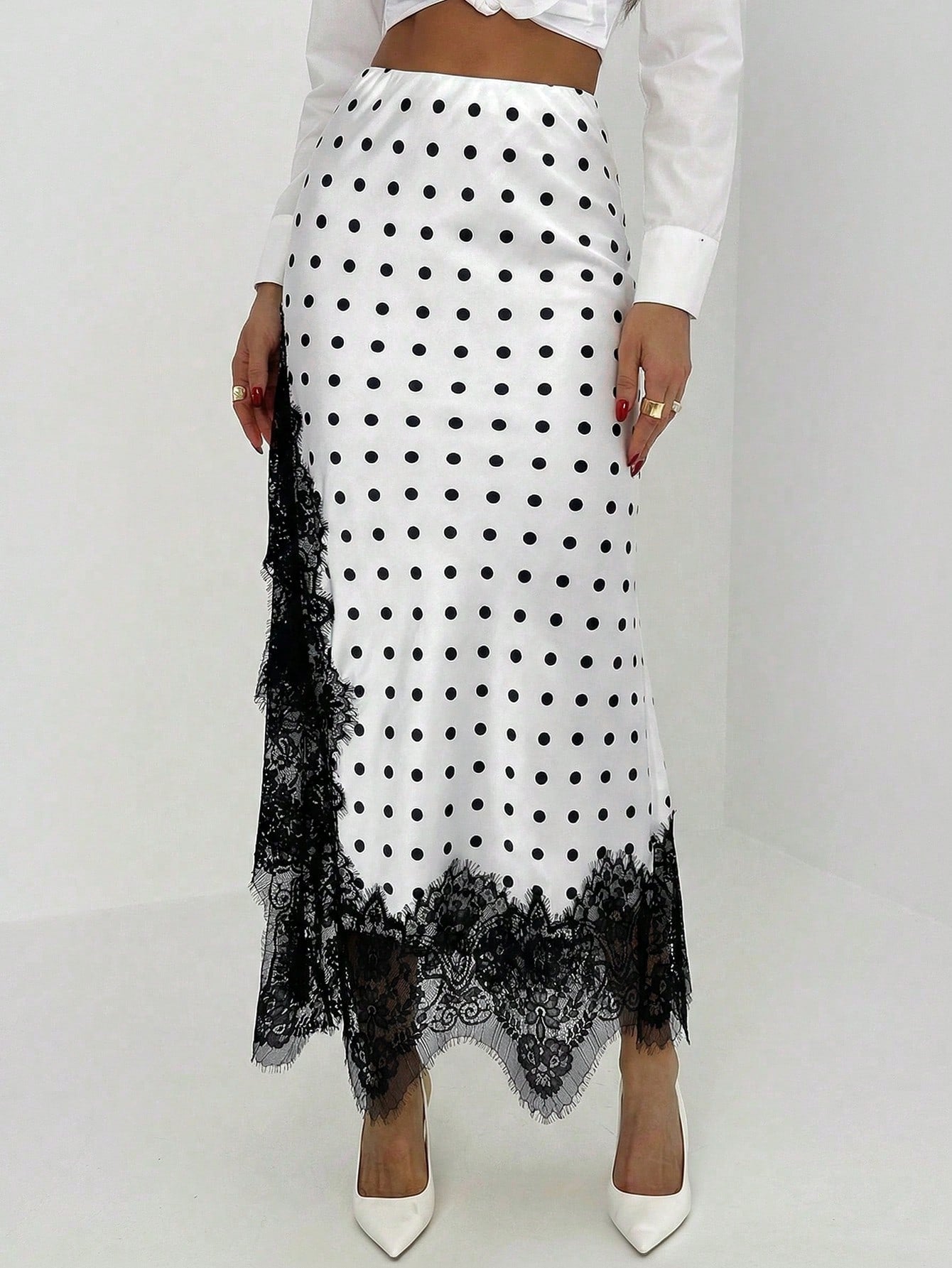 Women's elegant black lace patchwork mermaid maxi skirt featuring asymmetrical contrast lace design and low waist fit.