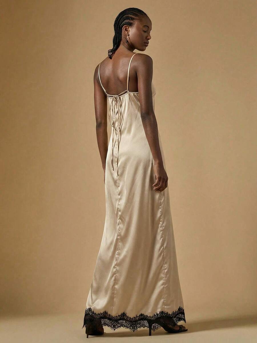 Women's black lace split satin long dress featuring spaghetti straps, asymmetrical slit hem, and matching arm sleeves.