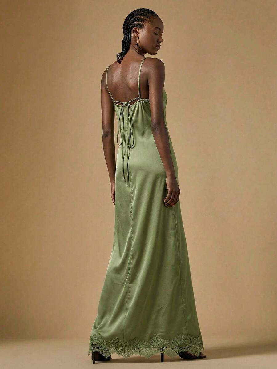 Women's black lace split satin long dress featuring spaghetti straps, asymmetrical slit hem, and matching arm sleeves.