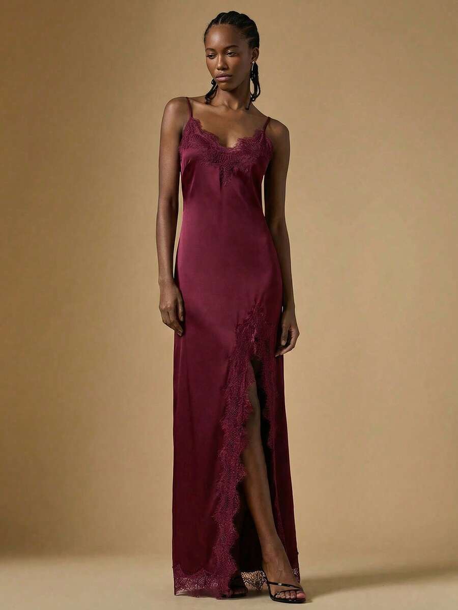 Women's black lace split satin long dress featuring spaghetti straps, asymmetrical slit hem, and matching arm sleeves.