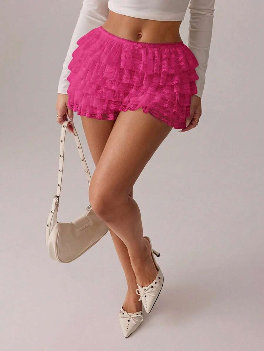 Apricot tiered lace ruffle hem low waist shorts for women featuring elastic waist and lined semi-sheer knit fabric.