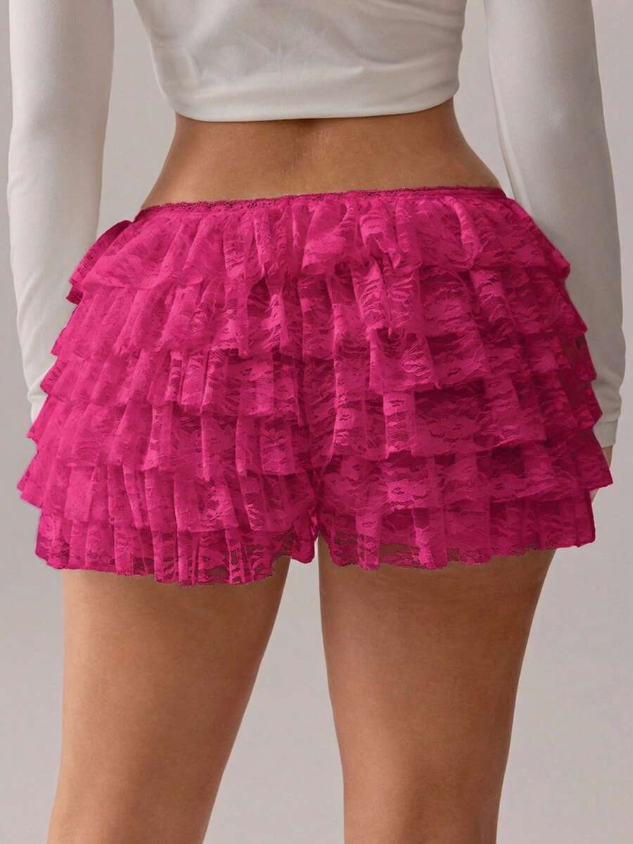 Apricot tiered lace ruffle hem low waist shorts for women featuring elastic waist and lined semi-sheer knit fabric.