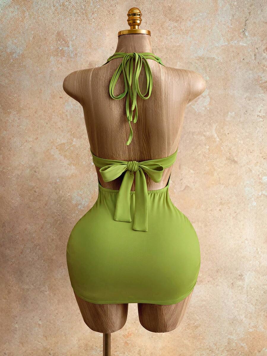 Sleeveless women's halter backless bodycon mini dress featuring lace-up knot back details and a high-waist pencil hem.