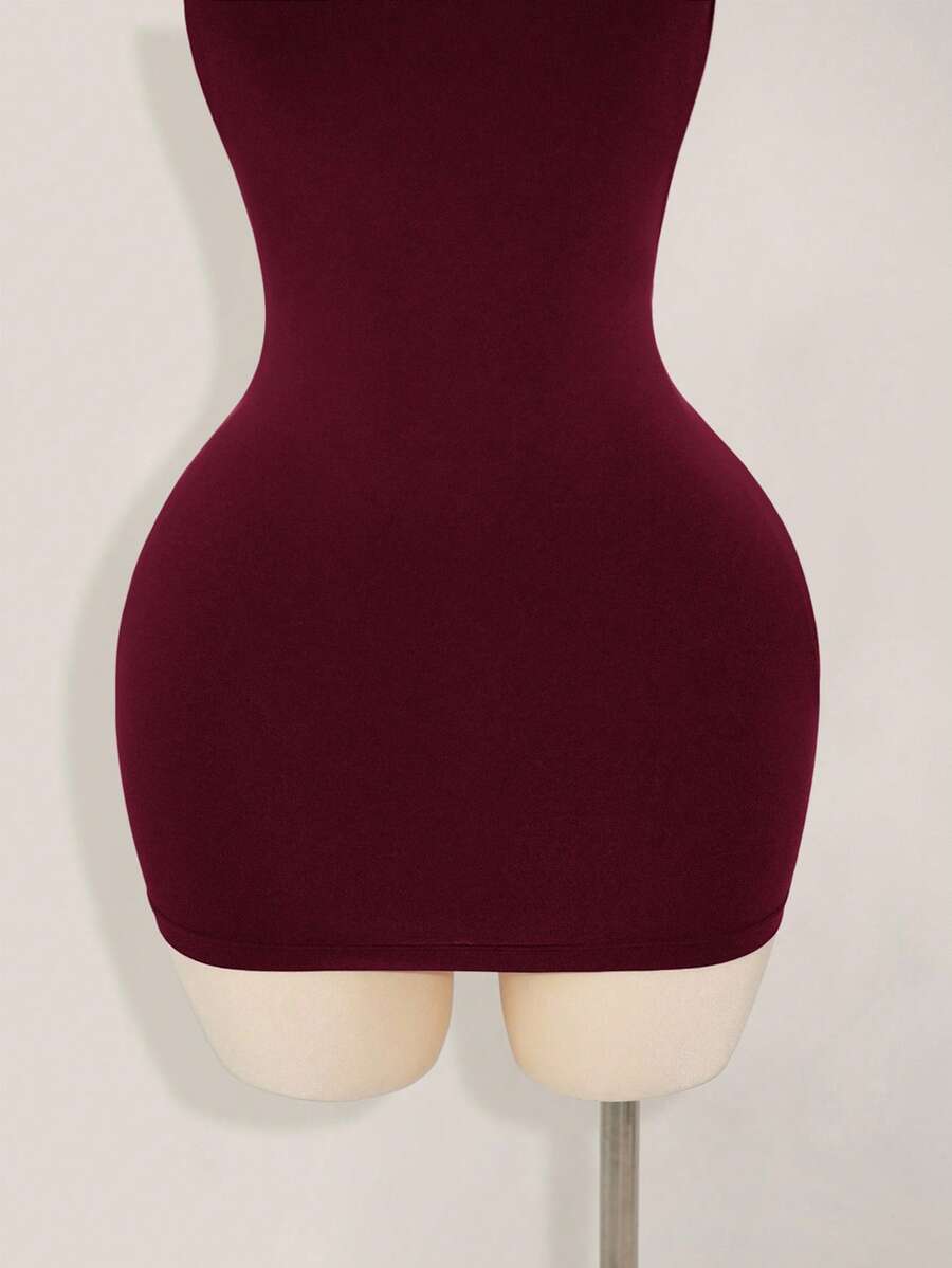 Apricot criss-cross backless bodycon mini dress for women featuring a round neck and rhinestone accent details.