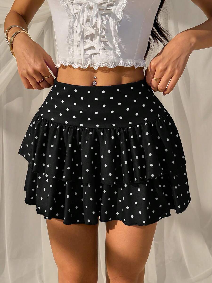 Black low waist knit mini skirt featuring a tiered ruffle hem and skinny high stretch fit.