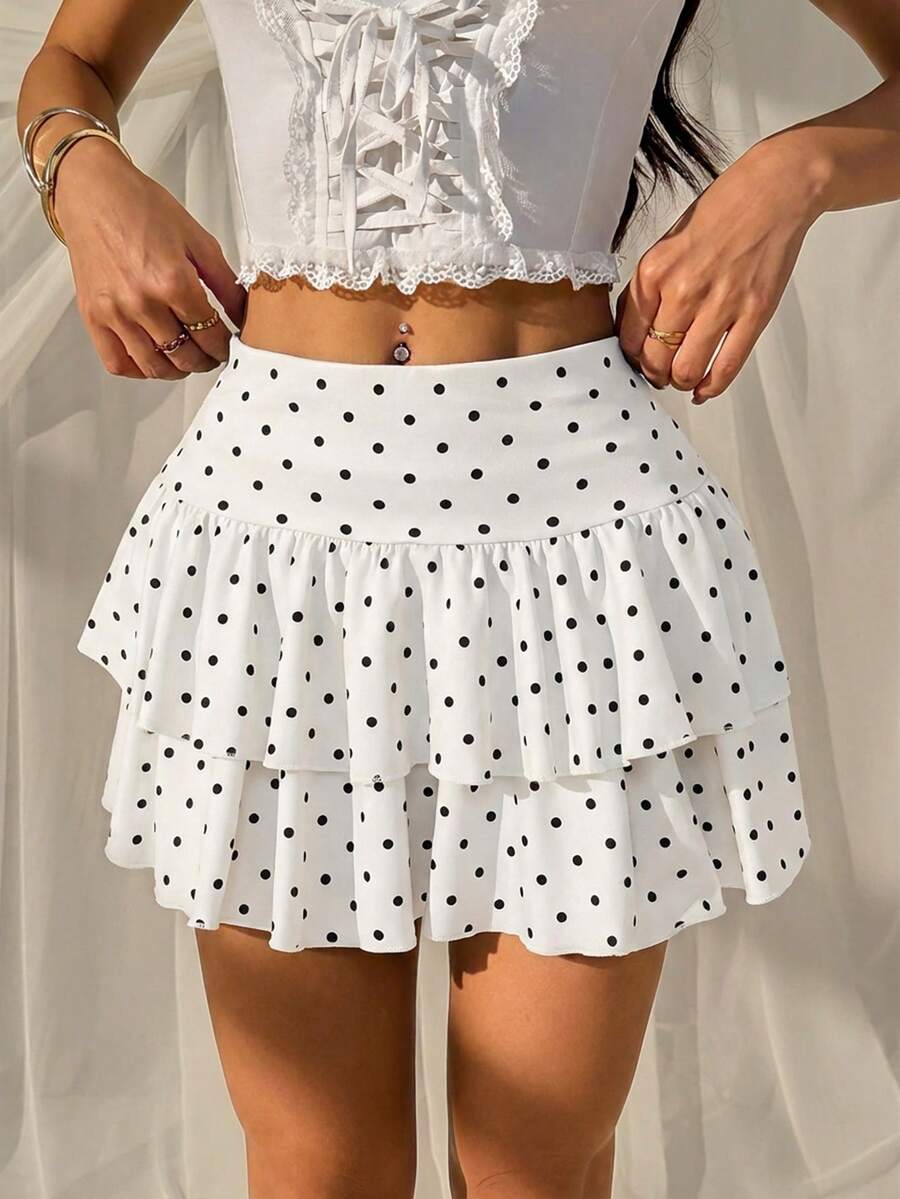 Black low waist knit mini skirt featuring a tiered ruffle hem and skinny high stretch fit.