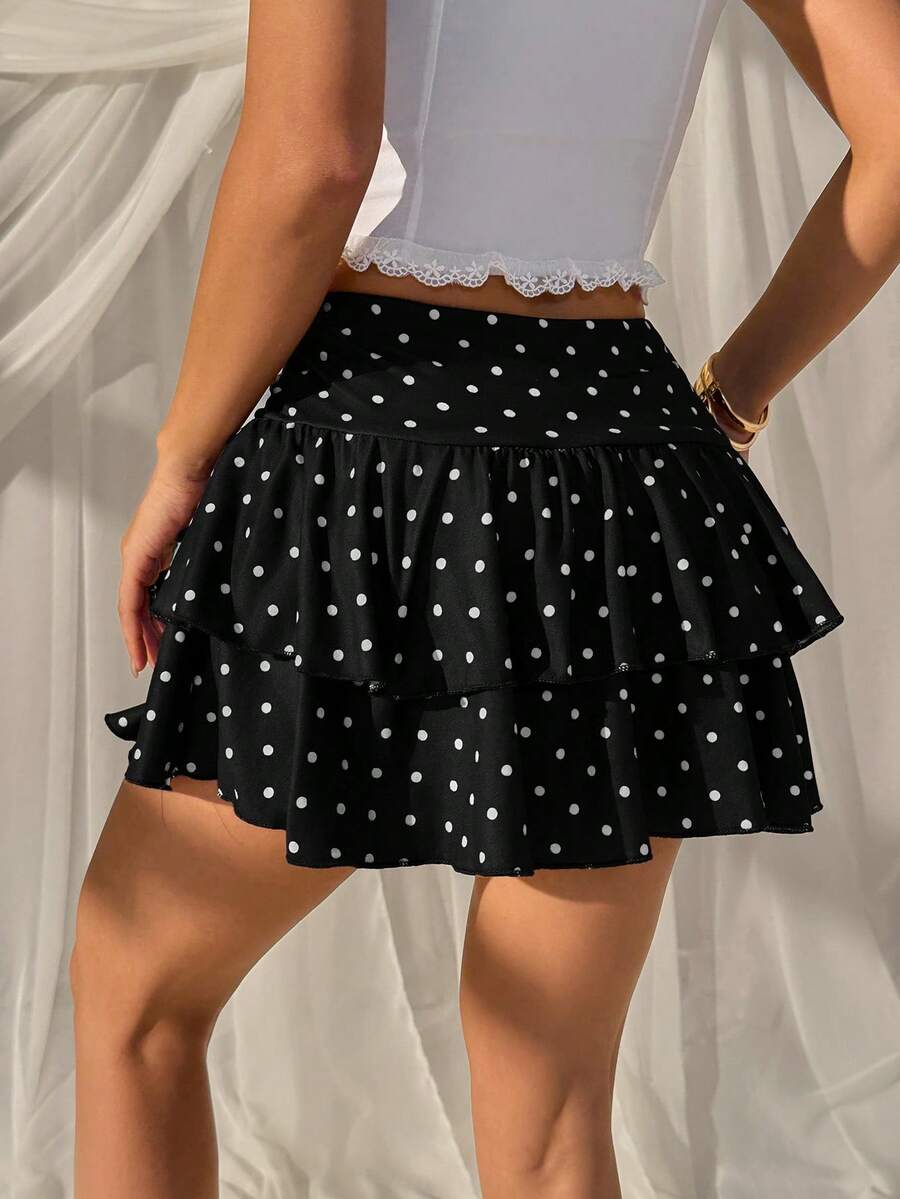 Black low waist knit mini skirt featuring a tiered ruffle hem and skinny high stretch fit.
