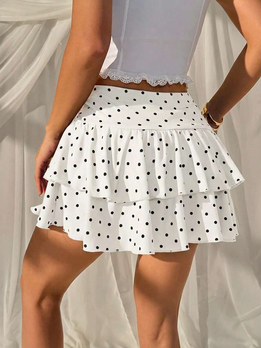 Black low waist knit mini skirt featuring a tiered ruffle hem and skinny high stretch fit.