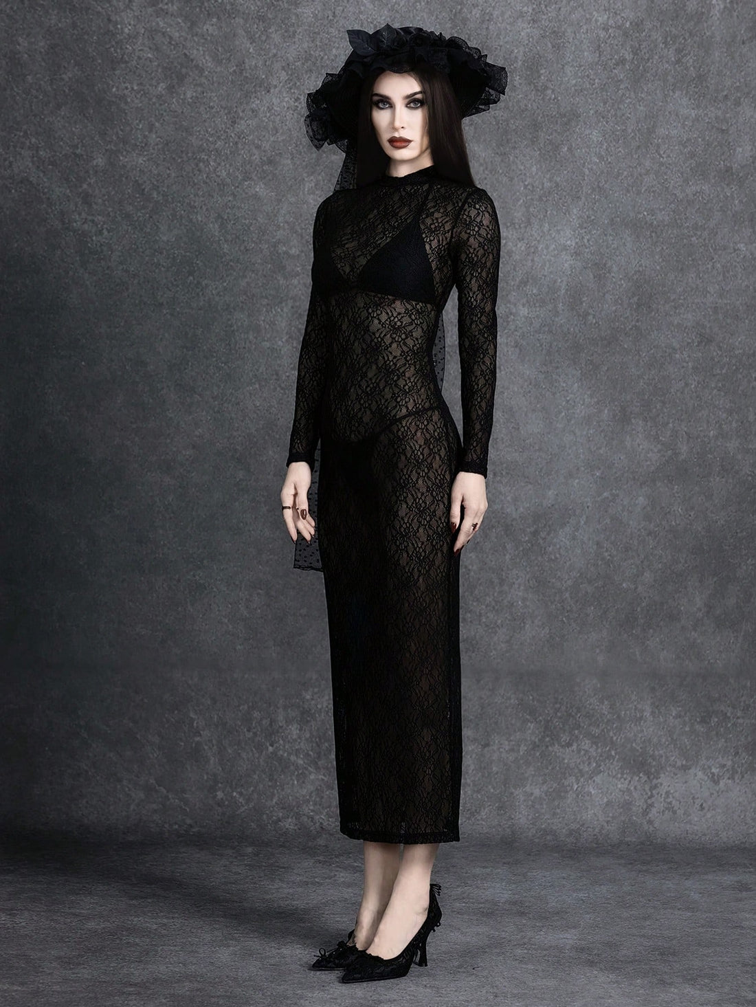 Women's black stand collar long sleeve slim fit maxi dress featuring a side slit hem and semi-sheer knitted fabric for evening wear.