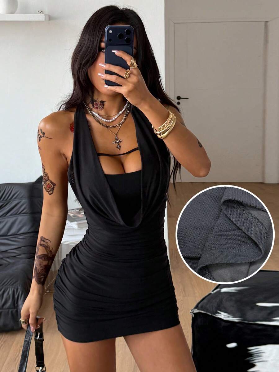 Women wearing a black halter bodycon mini dress with ruched draped detailing and a backless design made of high stretch knitted fabric.
