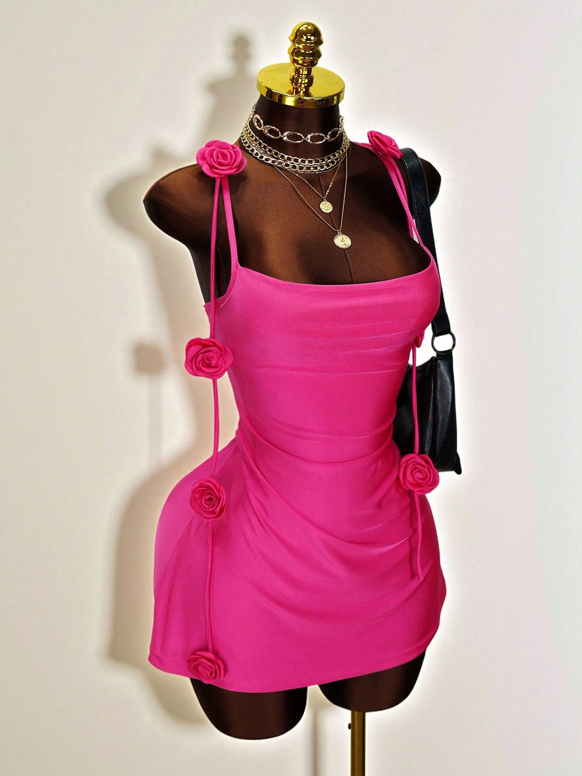 Women's bodycon mini dress featuring a 3D rose accent, thin spaghetti straps, and an open back design.