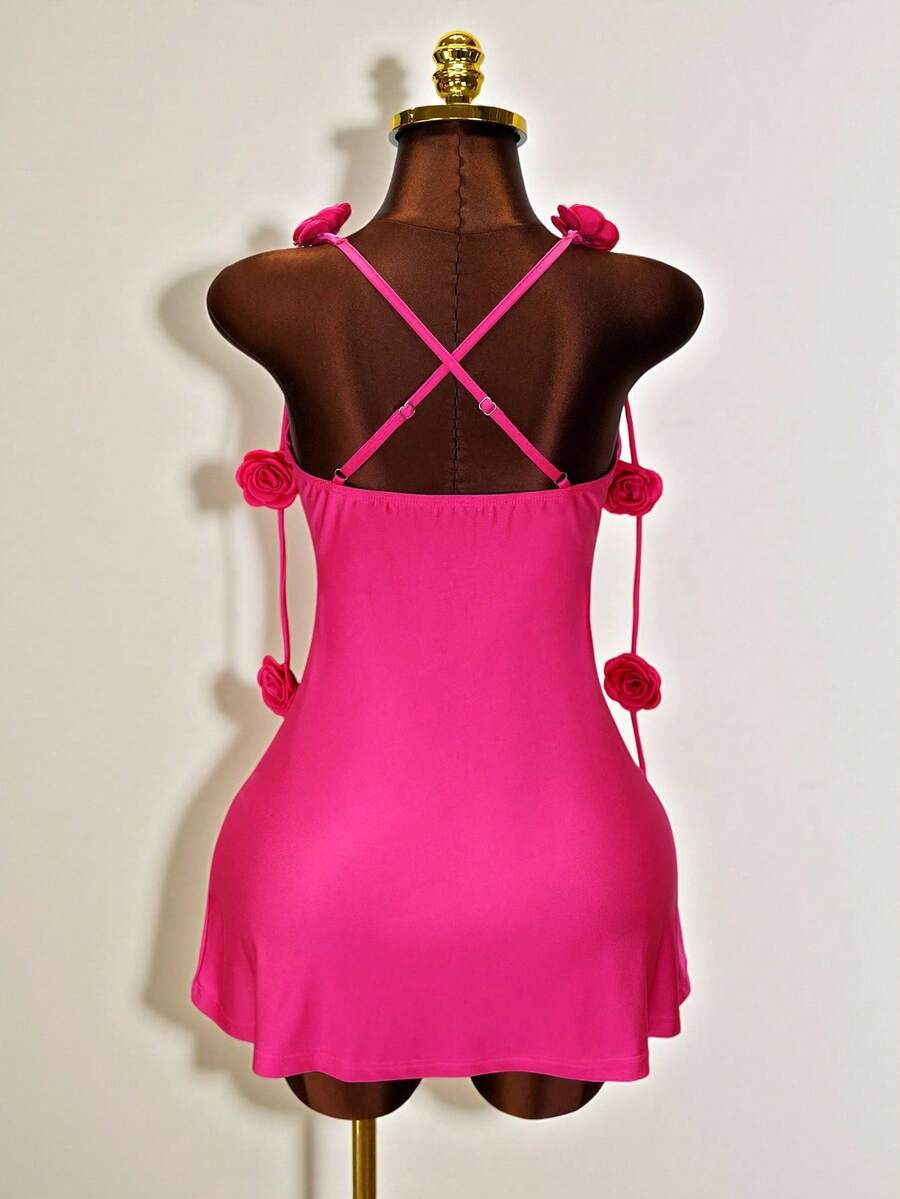 Women's bodycon mini dress featuring a 3D rose accent, thin spaghetti straps, and an open back design.