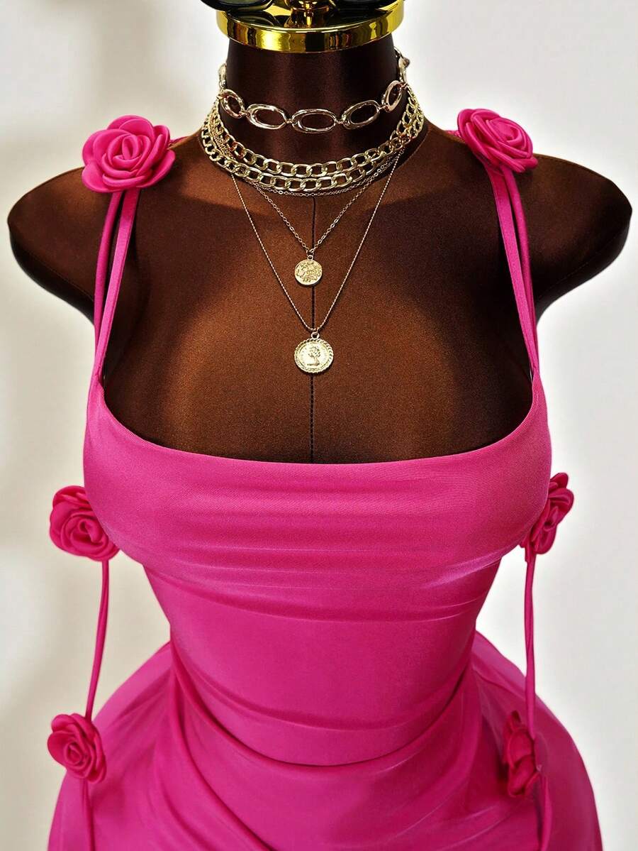 Women's bodycon mini dress featuring a 3D rose accent, thin spaghetti straps, and an open back design.