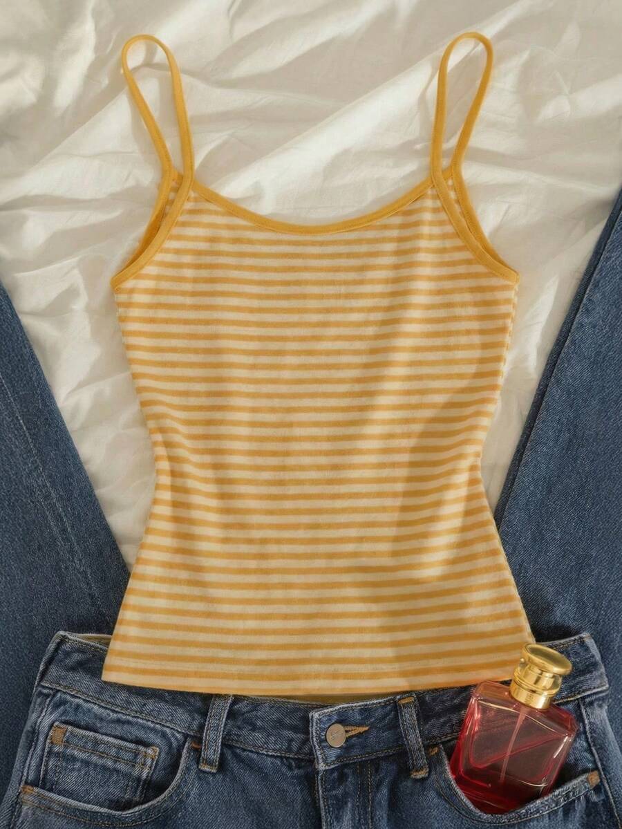 Women's pink striped crop camisole featuring criss cross spaghetti straps and slim fit design.