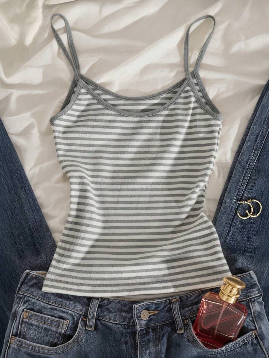 Women's pink striped crop camisole featuring criss cross spaghetti straps and slim fit design.