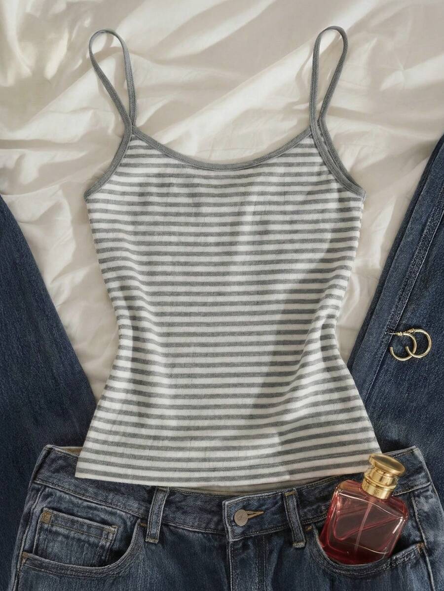 Women's pink striped crop camisole featuring criss cross spaghetti straps and slim fit design.