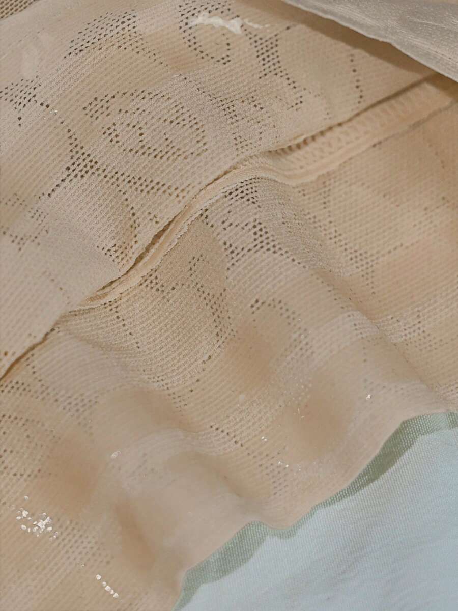Women's apricot body shaper jumpsuit with 4-row hook and eye front closure and contrast lace details.