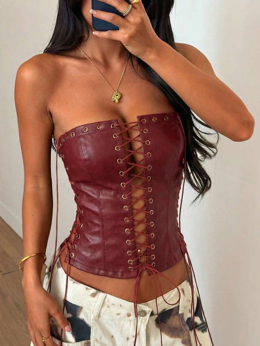 Women’s coffee brown faux leather lace-up crop top with strapless neckline, slit hem, and slim fitted silhouette for festival and nightlife wear.