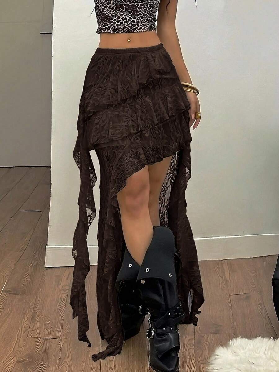 Women's black asymmetrical long skirt with ruffle hem and low waist design in knitted fabric.