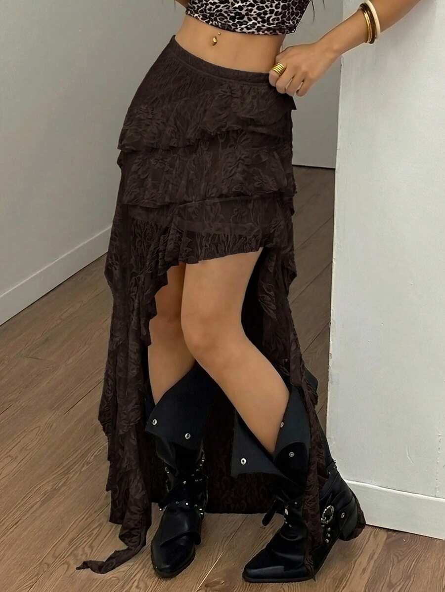 Women's black asymmetrical long skirt with ruffle hem and low waist design in knitted fabric.