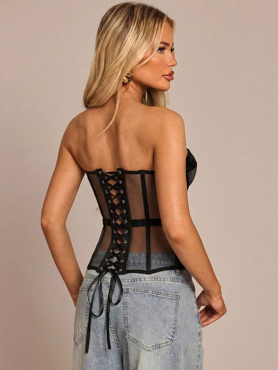 Women's black mesh patchwork bustier corset crop top with sweetheart neckline and asymmetrical hem.