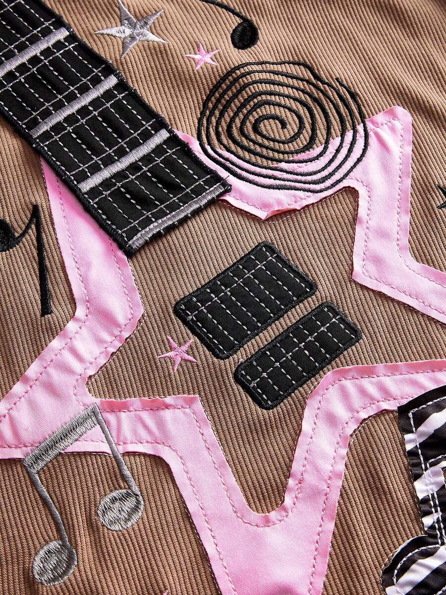 Women's bass note graphic print crop camisole top featuring lace-up detailing, spaghetti straps, and a slim fit knitted design.
