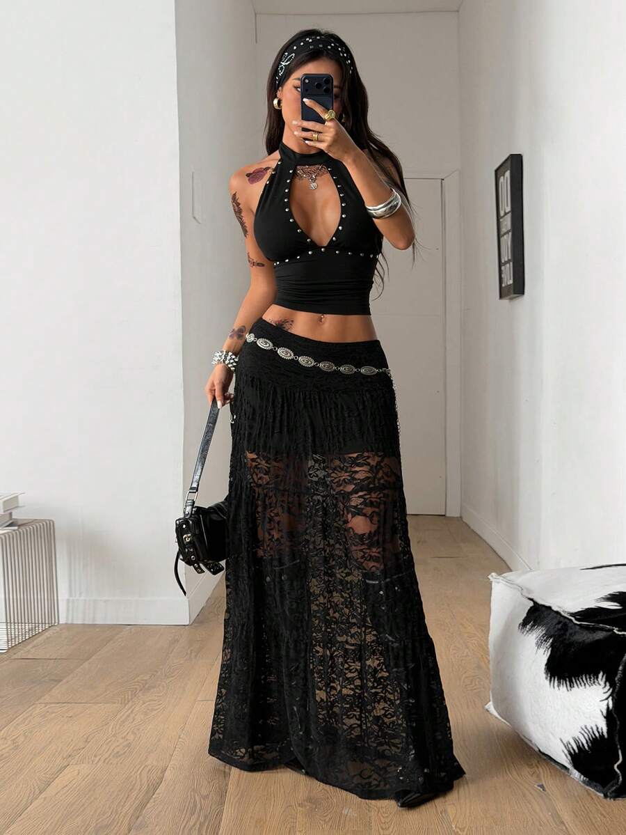 Women's black low waist split thigh long skirt featuring semi-sheer textured fabric and a flared skinny fit.