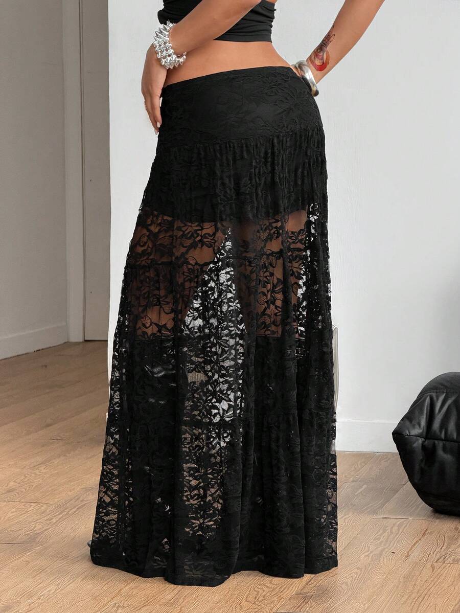 Women's black low waist split thigh long skirt featuring semi-sheer textured fabric and a flared skinny fit.