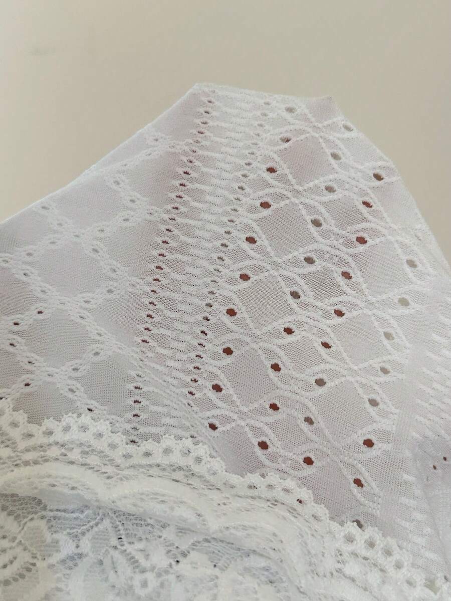 Black and white polka dot knit camisole tank top featuring delicate contrast lace trim, a cute bow accent at the sweetheart neckline, and slender shoulder straps.