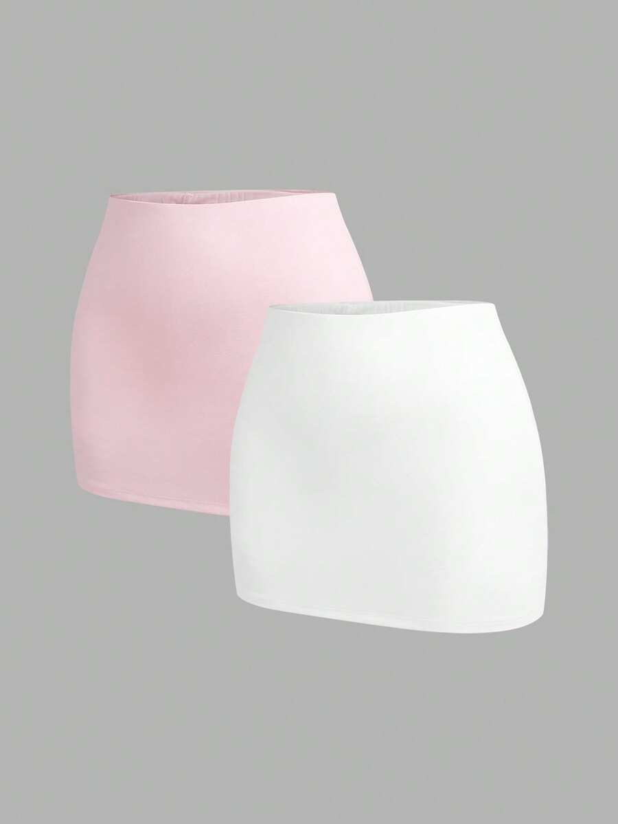 Women's black casual low rise bodycon mini skort with built-in shorts in knitted plain stretch fabric.