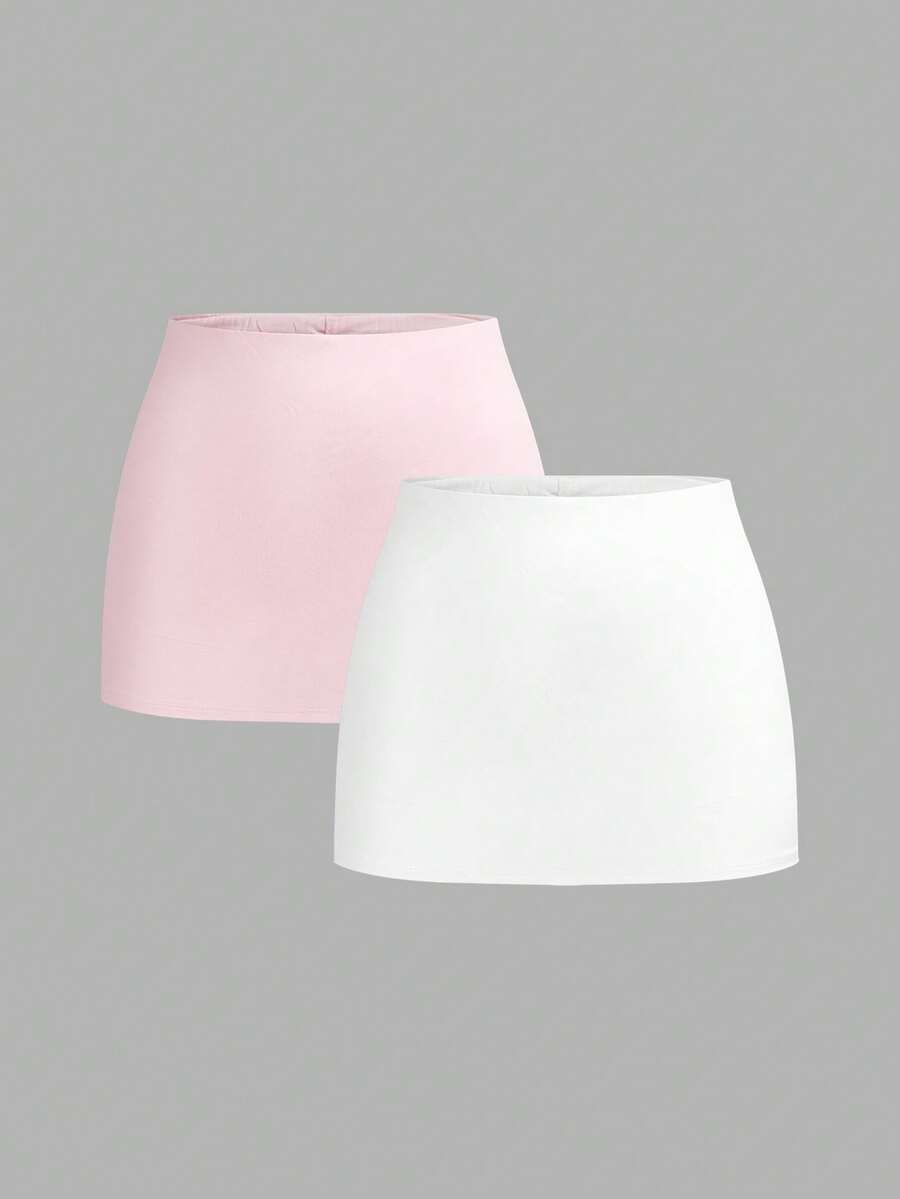 Women's black casual low rise bodycon mini skort with built-in shorts in knitted plain stretch fabric.